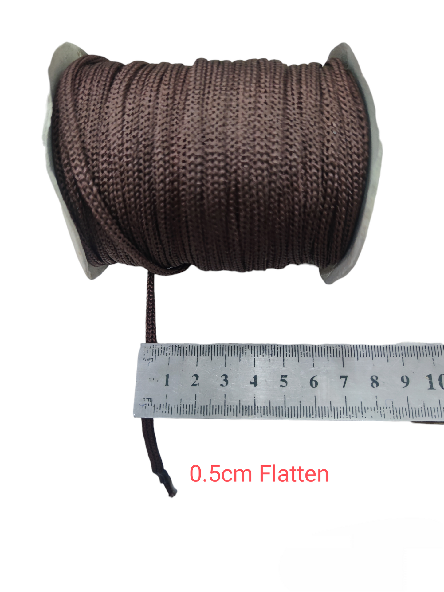 Brown cloth rope rolled on spool with 0.5 cm width next to ruler measuring cloth rope per meter