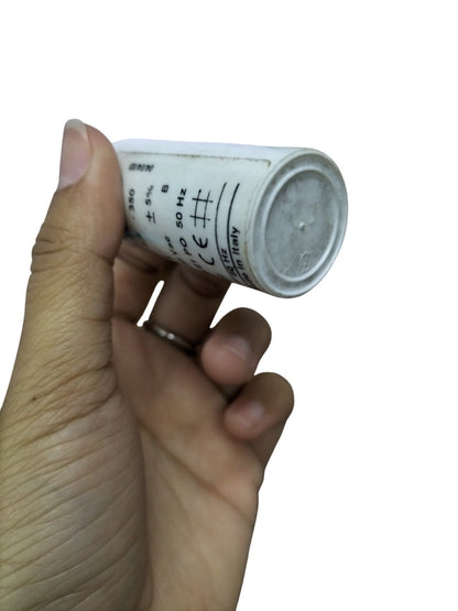 Comar Motor Running Capacitor 350V AC held in hand, ideal for improving motor performance