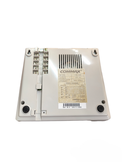 Back view of Commax 4 station intercom system showing connection terminals and label