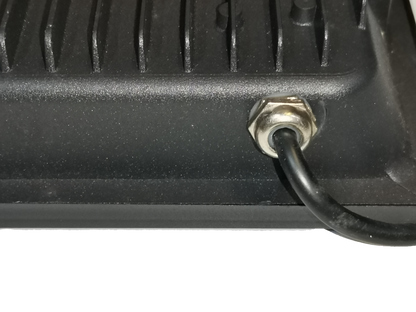 Close-up of DENKO 30W 220V outdoor LED light black power cable connection showing heat sink fins