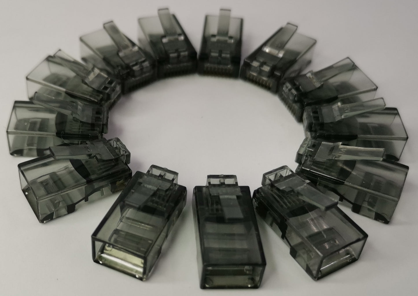 Grippes Denko RJ45 Connector colored transparent network cable connectors arranged in a circle