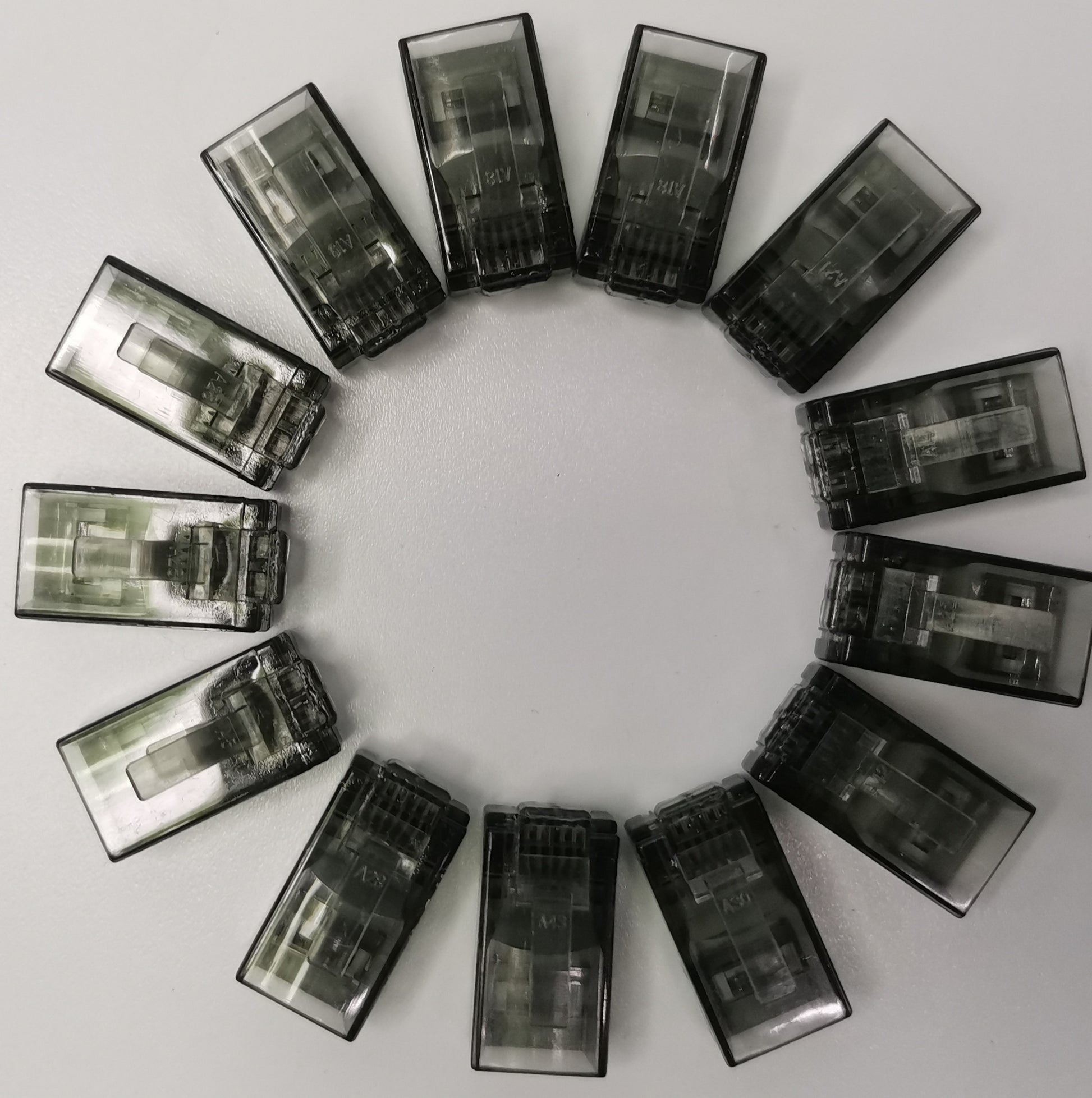 Circle of transparent black Denko RJ45 Connector colored adapters for powerline network connections