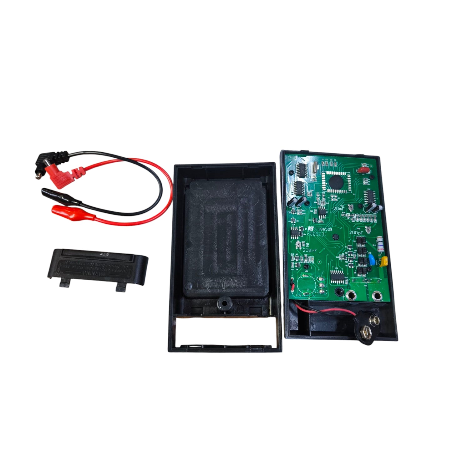 Digital capacitance tester circuit board with battery cover and test leads for electrical measurements