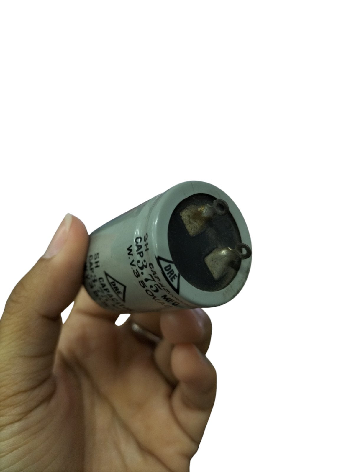 DRE 350V AC motor running capacitor held in hand for electrical circuit applications