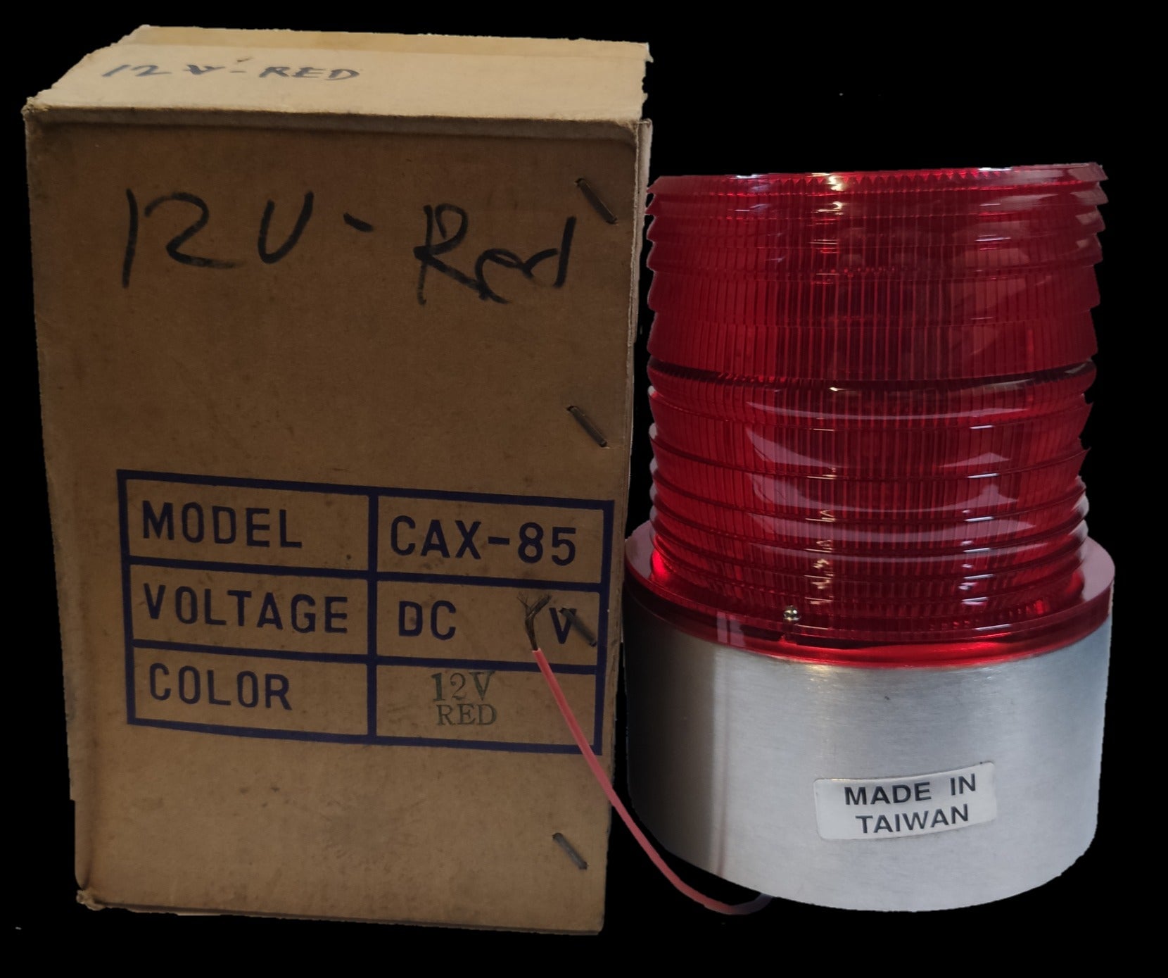 Sub Zero seasonal decorative flashing light red 12V DC with red lens and silver base next to cardboard box