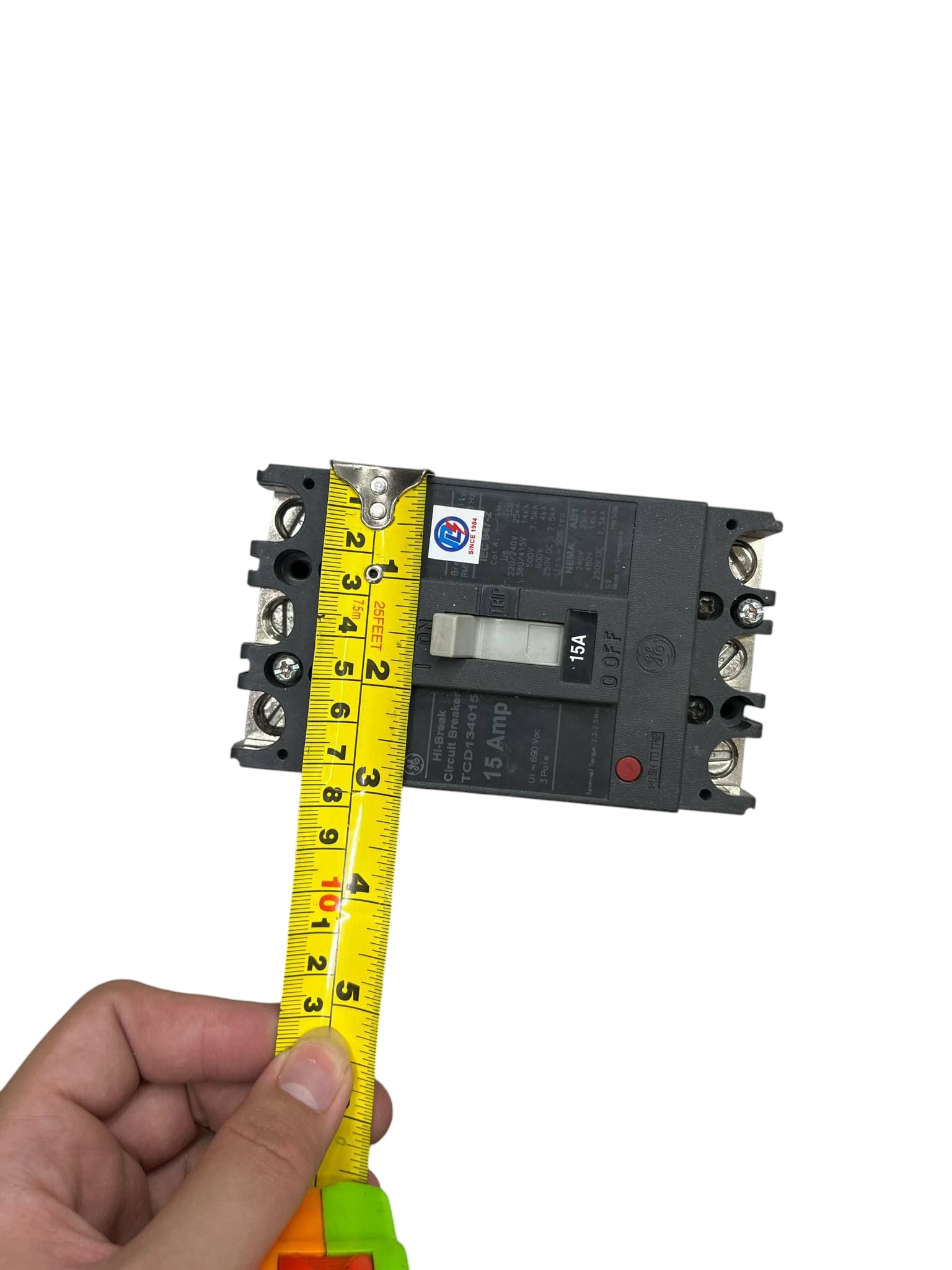 GE 15A 3Pole Industrial Circuit Breaker 220V held with tape measure showing size