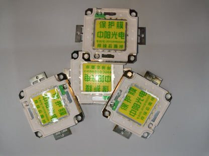 Four China-made 20w high power LED chip components arranged on a gray surface
