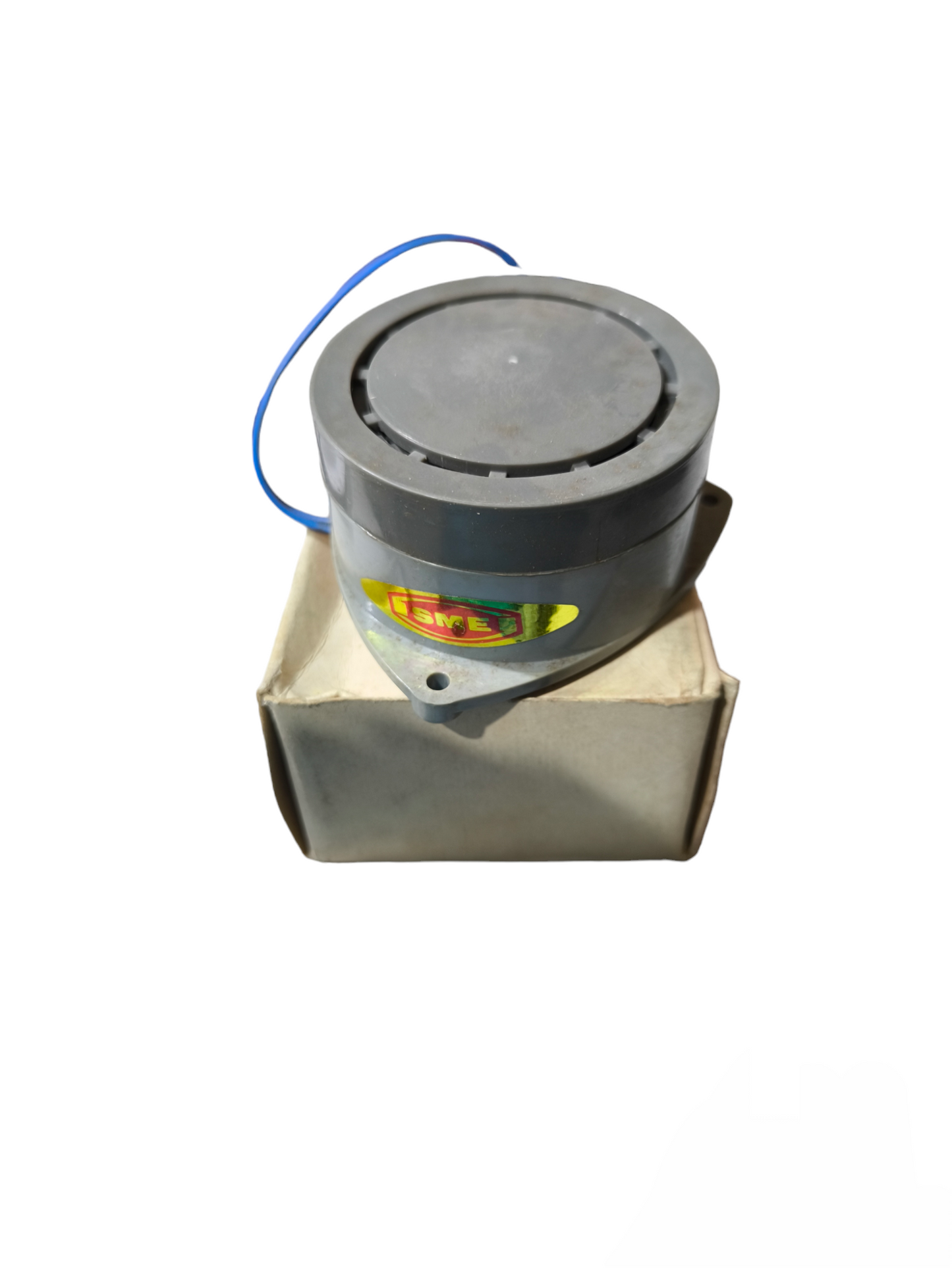 220V panel buzzer door chime in black placed on a beige cardboard box from China vendor