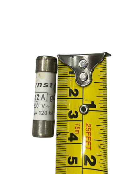 Ceramic Fuse 12A 500V 10x38mm electrical component next to yellow measuring tape for size reference
