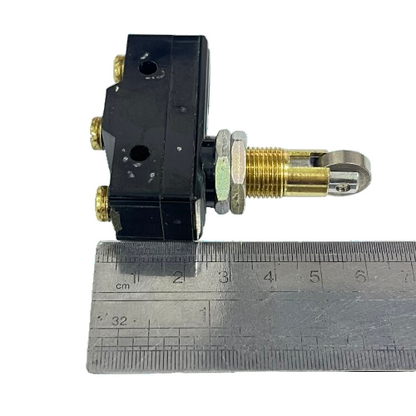 Tend Limit Switch 15A 250VAC TM1309 small black plastic body with roller plunger and screw terminals next to ruler