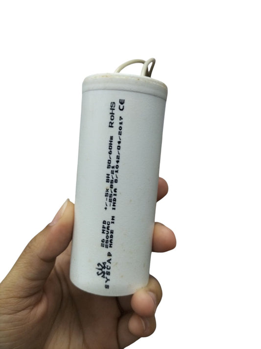 Syscap motor running capacitor with white cylindrical body and wires
