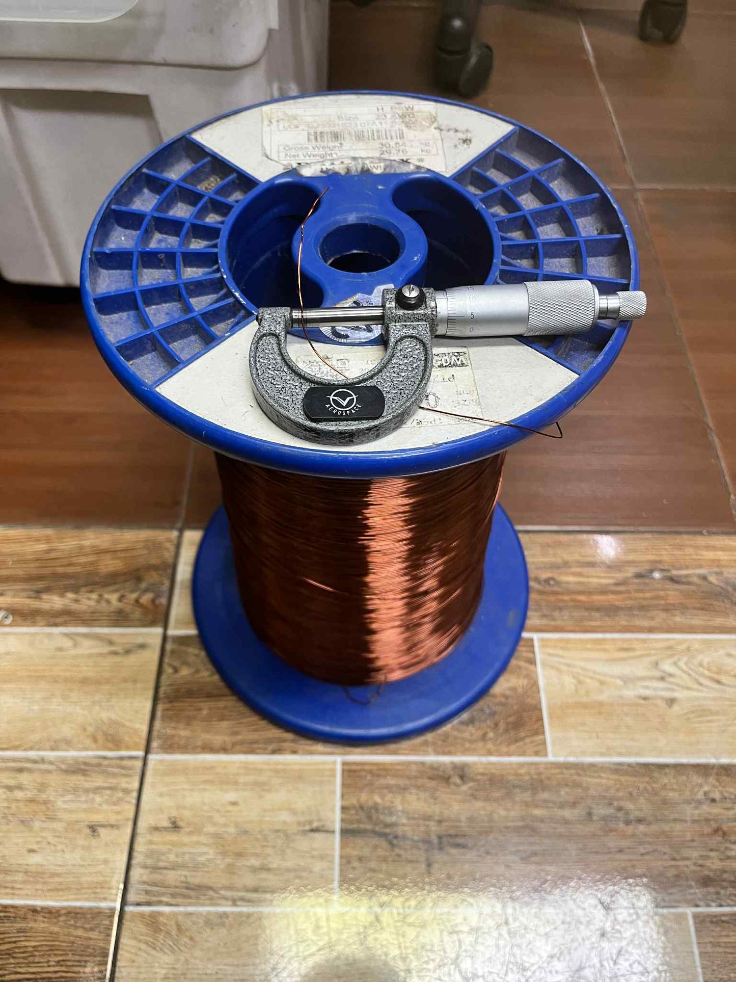 Philflex heavy Formix magnet wire AWG 23 400G on a spool with a micrometer for measuring diameter