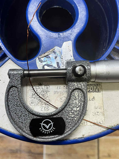 Micrometer measuring Heavy Formix magnet wire AWG 23 900G on a spool for quality control