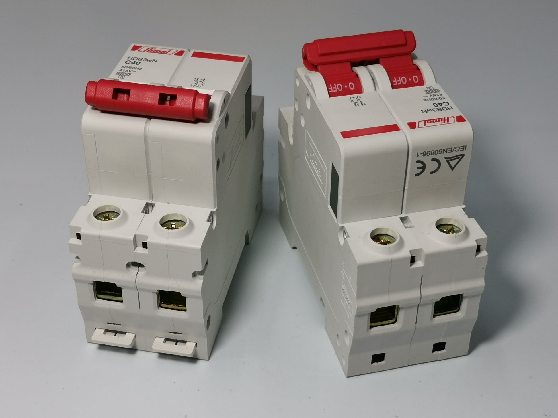 Two white Himel 40A MCB 2 pole circuit breakers with red toggle switches for DIN rail mounting
