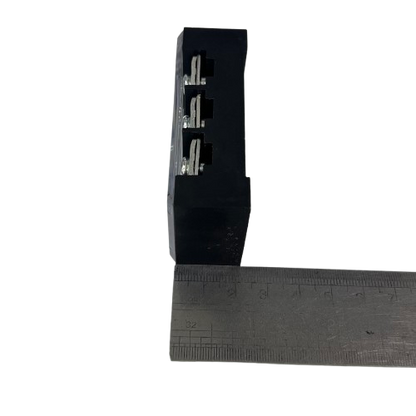 Grippes 45A 3 Pair Terminal Block 600V black plastic with three metal contacts shown beside ruler for scale