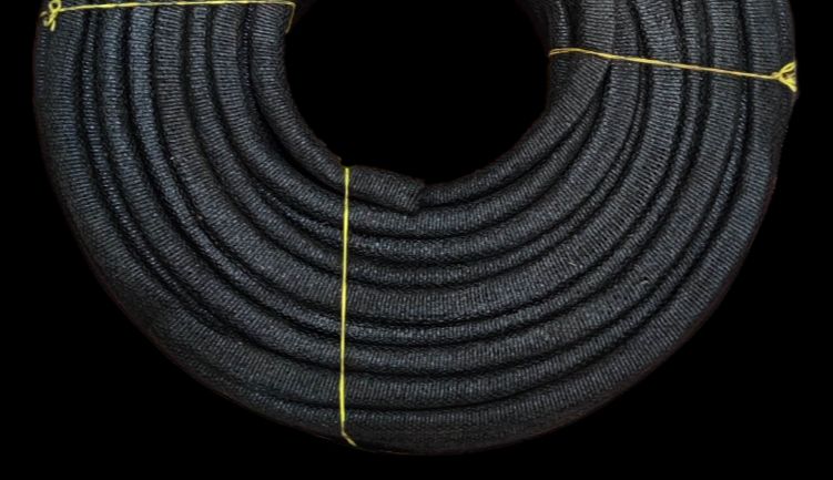 Coiled black mica electrical insulation tubing braided protective sleeve tied with yellow twine for wiring