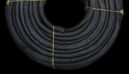 Coiled black mica electrical insulation tubing braided protective sleeve tied with yellow twine for wiring