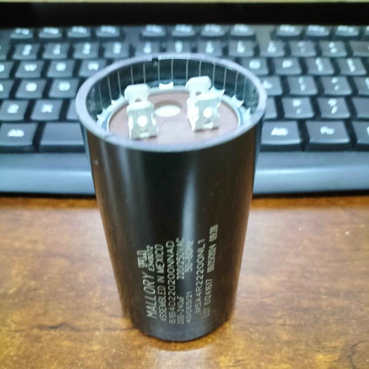 Mallory motor capacitor black cylindrical electrical component with metal terminals