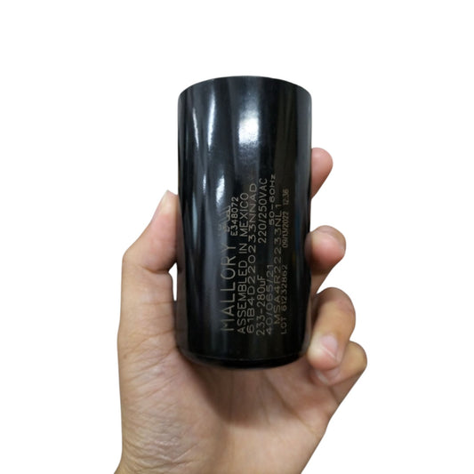 Mallory motor starting capacitor 233-280MFD in a hand, designed for reliable electrical performance
