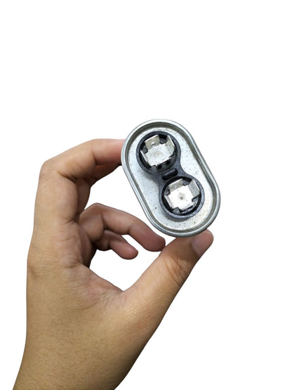 Mallory oil-filled running capacitor 440V AC held in hand, showcasing dual terminals and robust design