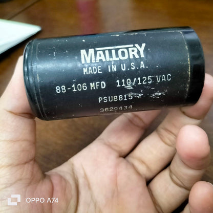 Mallory black electrical starting capacitor 88-106 MFD held in hand for circuitry use