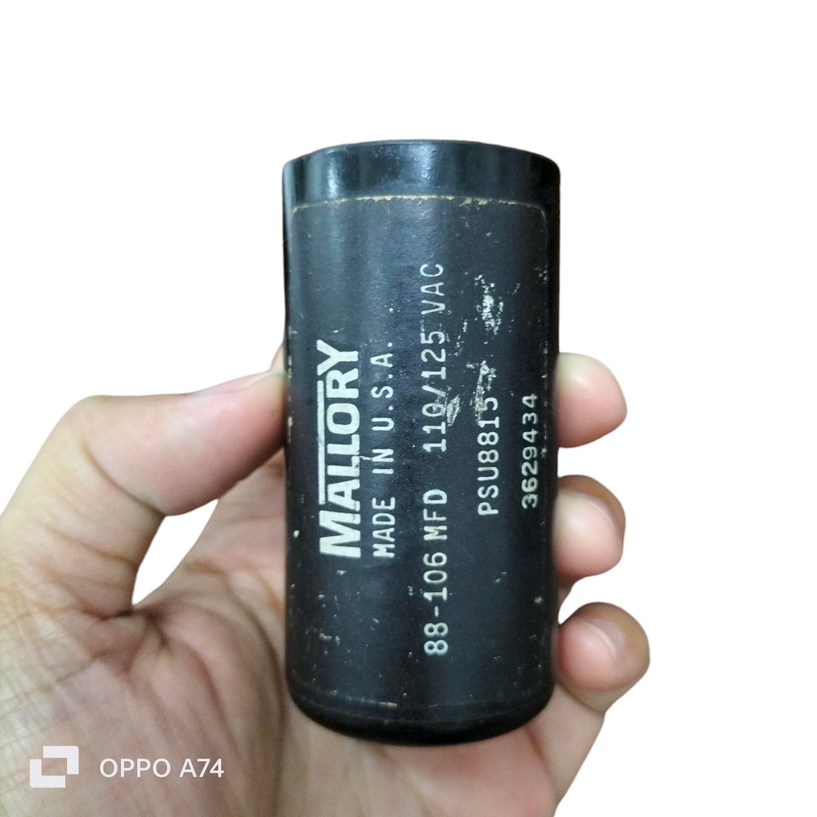 Mallory Starting Capacitor 88-106 MFD black cylindrical electrical part held in hand