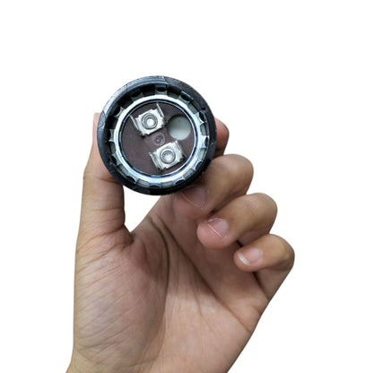 Mallory Starting Capacitor 88 to 106UF 330V held in hand showcasing its compact design