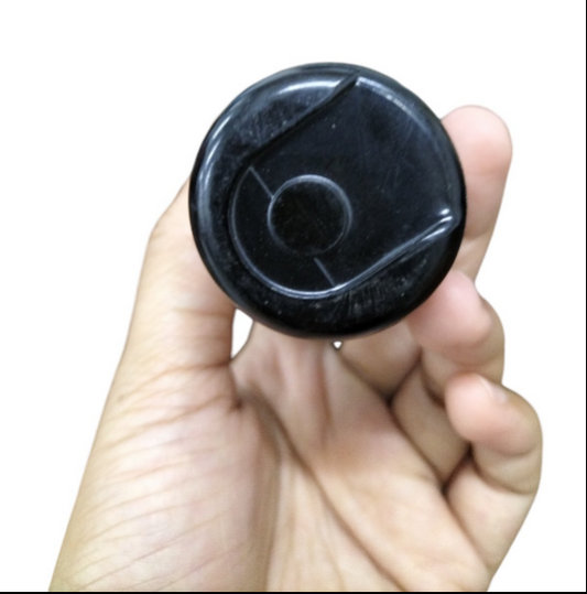 Hand holding a Motor Capacitor 324-389uf 165V showcasing the top view of the part