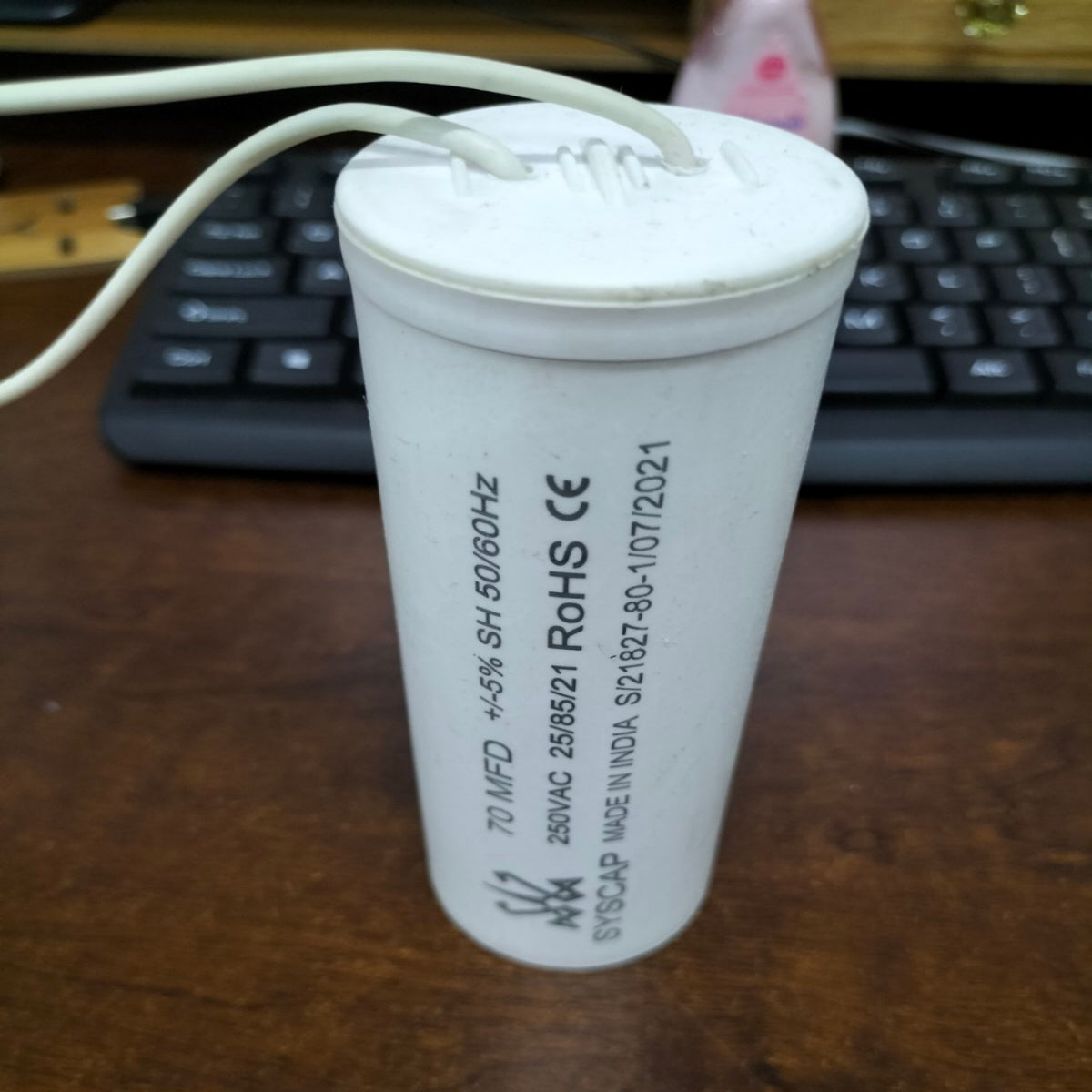 Syscap 70MFD 250V motor capacitor with white cylindrical design for electrical applications