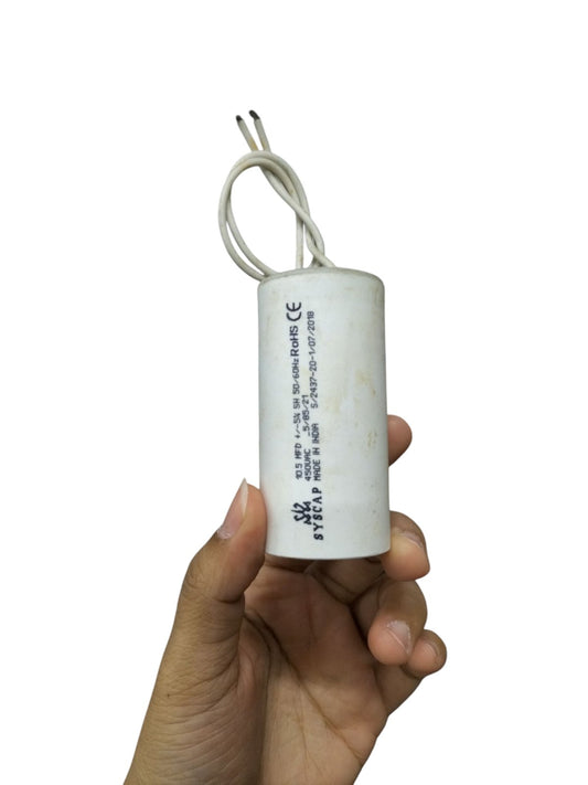 Syscap Motor Run Capacitor 450V held in hand for electrical circuit applications