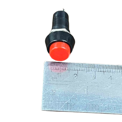 Normally Open Monetary Switch Red 1A with a push button design next to a ruler for size reference