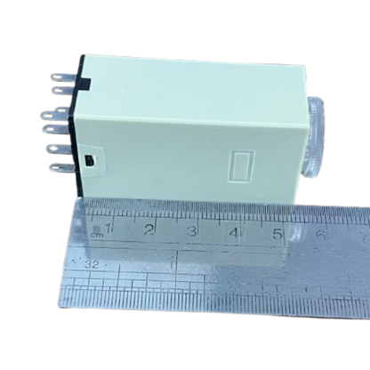 OMRON Timer Relay 30 seconds 8 pins 110V compact beige rectangular housing with adjustment dial and visible pins next to ruler