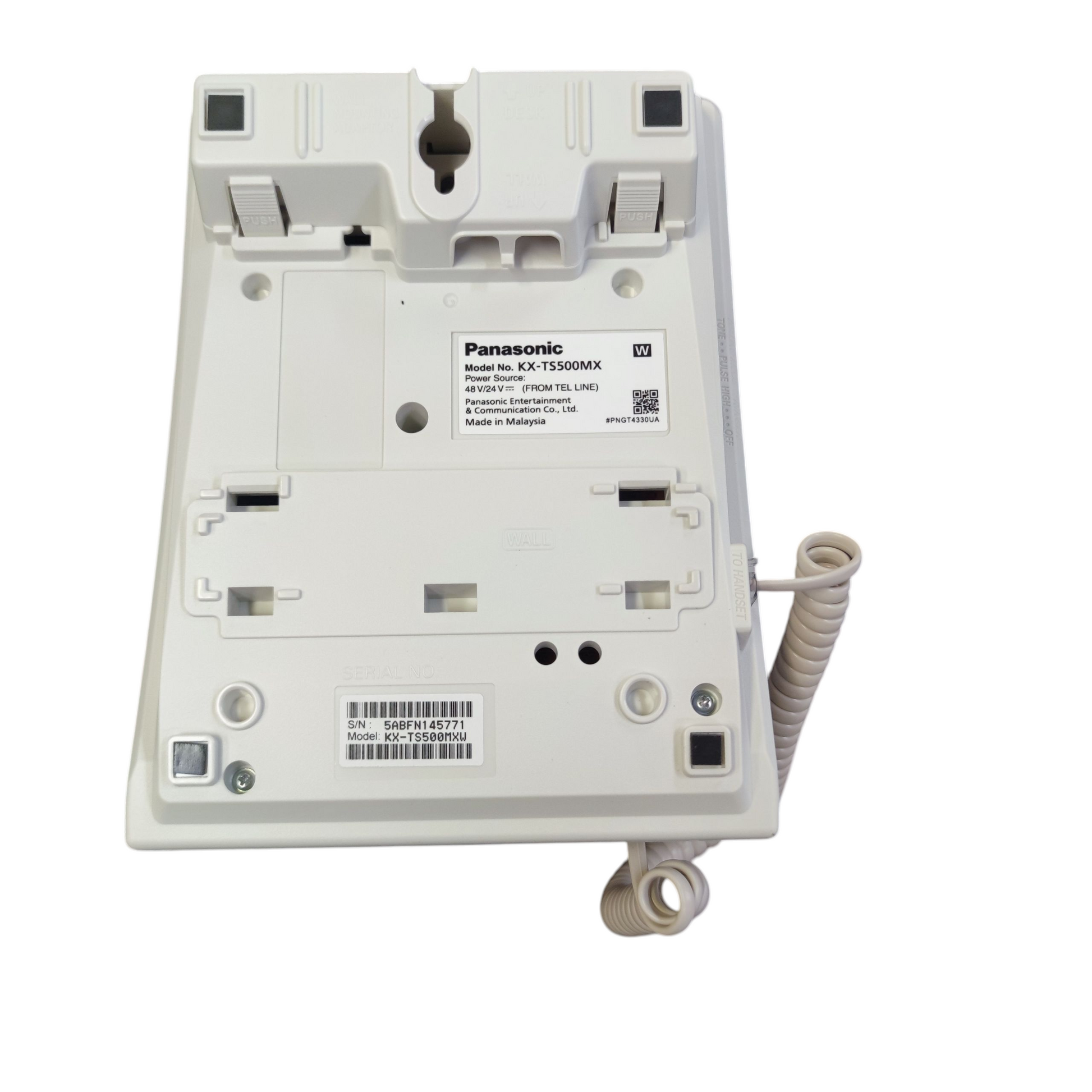 Back view of Panasonic desk phone showing model number KX-TS500MX with cord and mounting slots