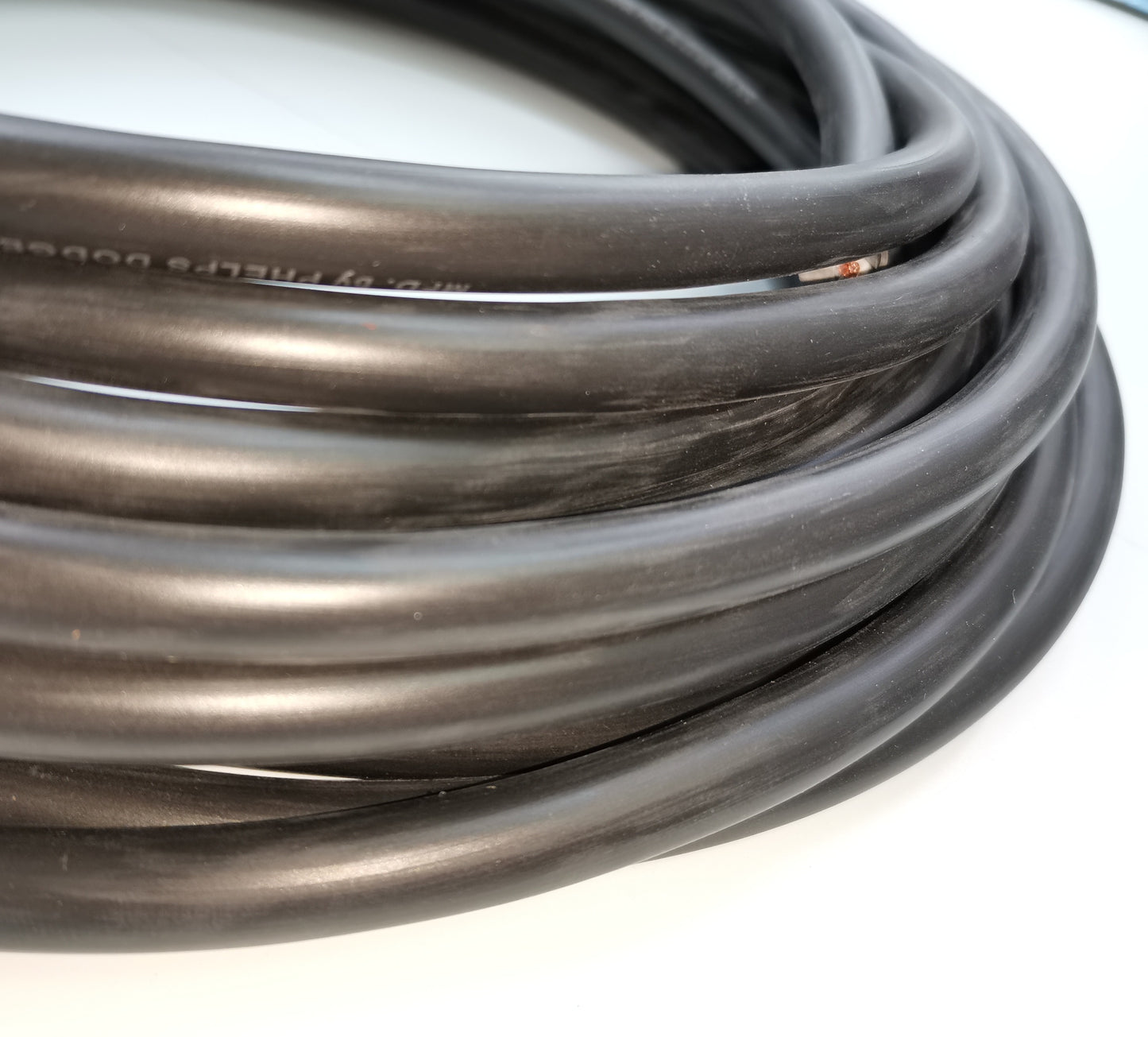 Coiled black Phelps Dodge perma cord wire with durable insulation for electrical applications