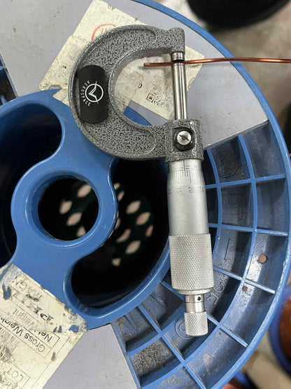 Philflex magnet wire AWG 14 600G being measured with a micrometer on a blue spool
