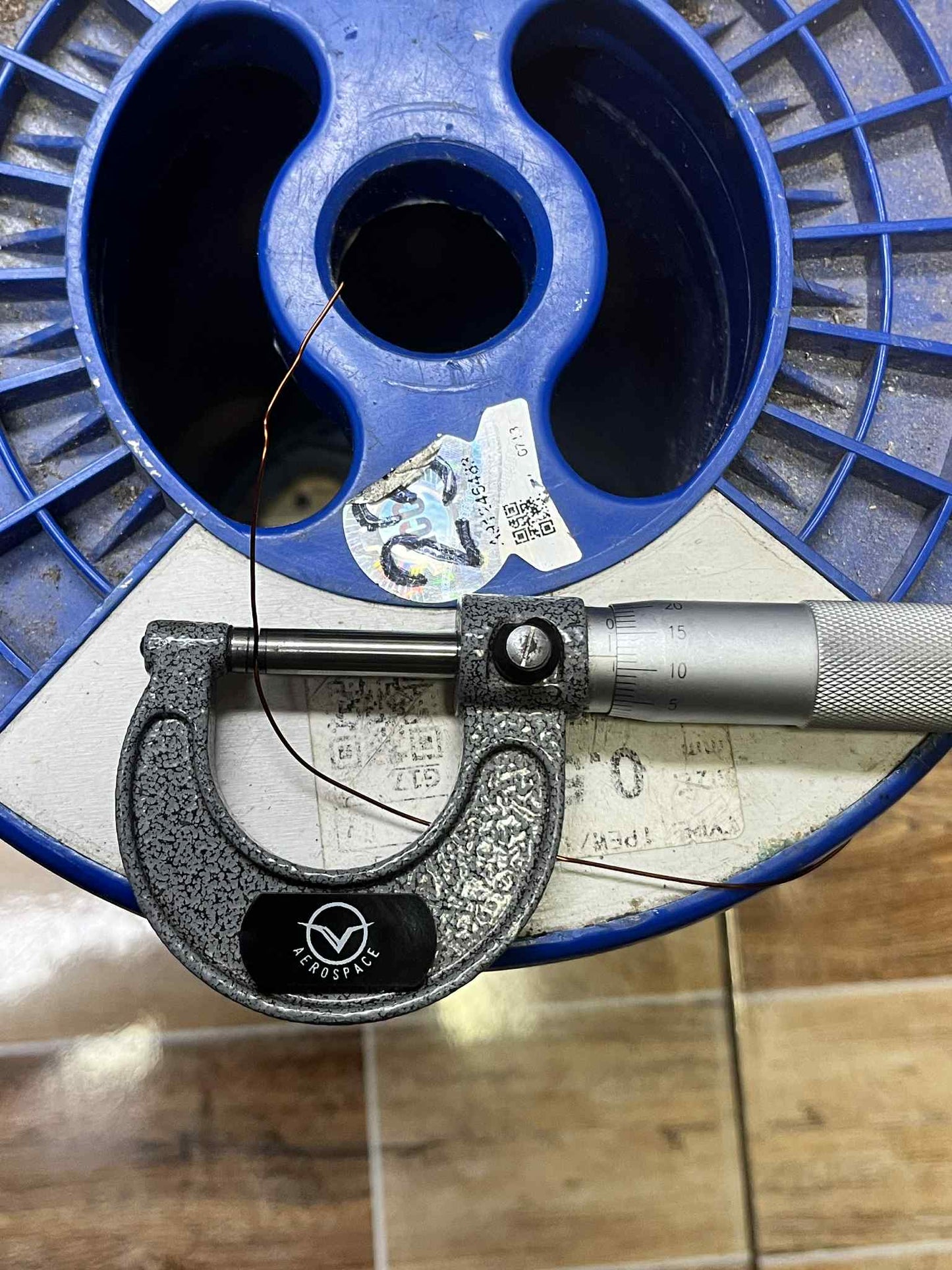 Philflex magnet wire AWG 23 shown being measured with a micrometer on a spool