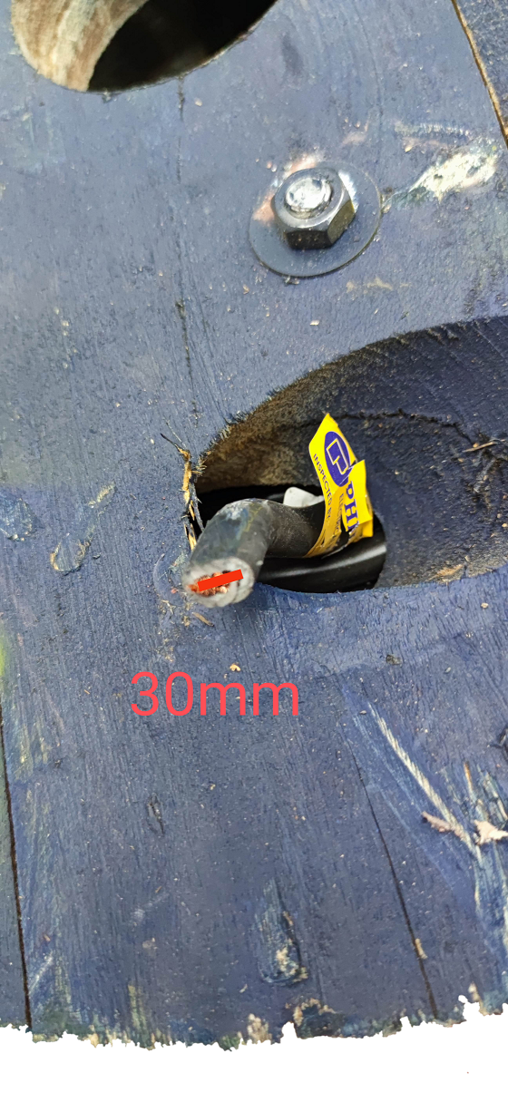 Close up of Philflex 30mm welding cable with exposed red copper conductor and yellow label on wooden spool