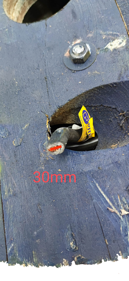 Close up of Philflex 30mm welding cable with exposed red copper conductor and yellow label on wooden spool