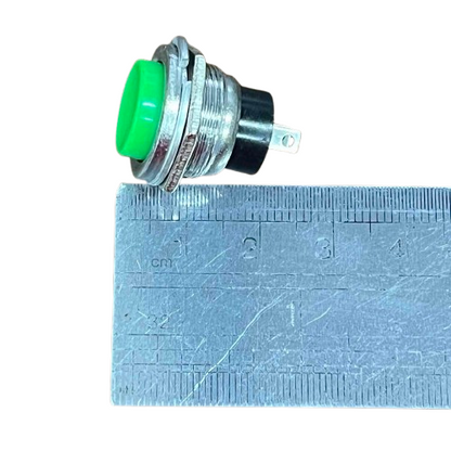 Push button 1A 220V green NO with a metallic casing and clear dimensions shown next to a ruler