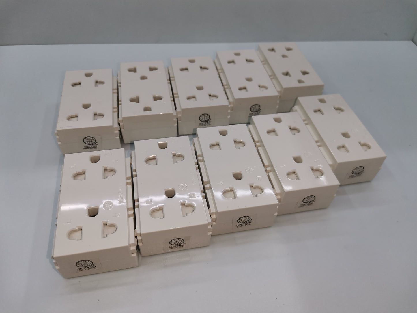 Royu Universal Outlet with Ground RWO11 multiple white electrical power sockets arranged on a surface