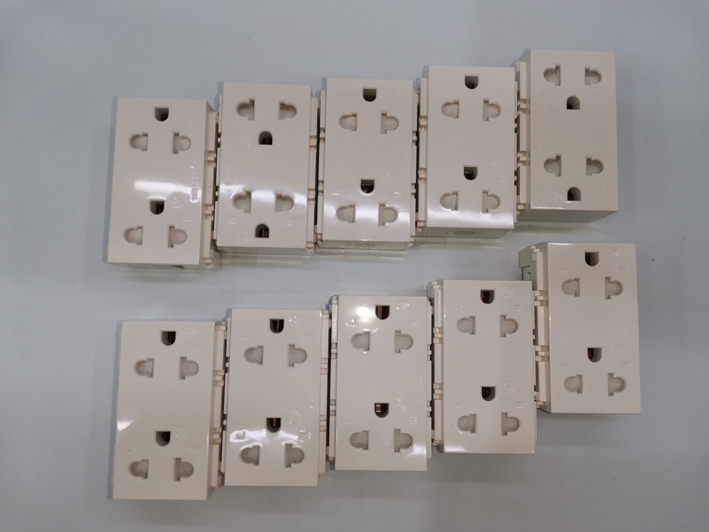 Royu Universal Outlet with Ground RWO11 multiple white power points and plugs arranged on a surface