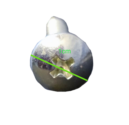 Close-up of a silver 1x2 cm Phillips screw pack showing detailed head design for hand tools