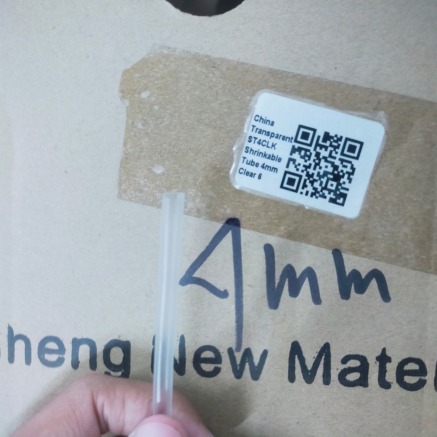 Shrinkable Tube Clear - 4mm transparent cable management tube held in hand with product label