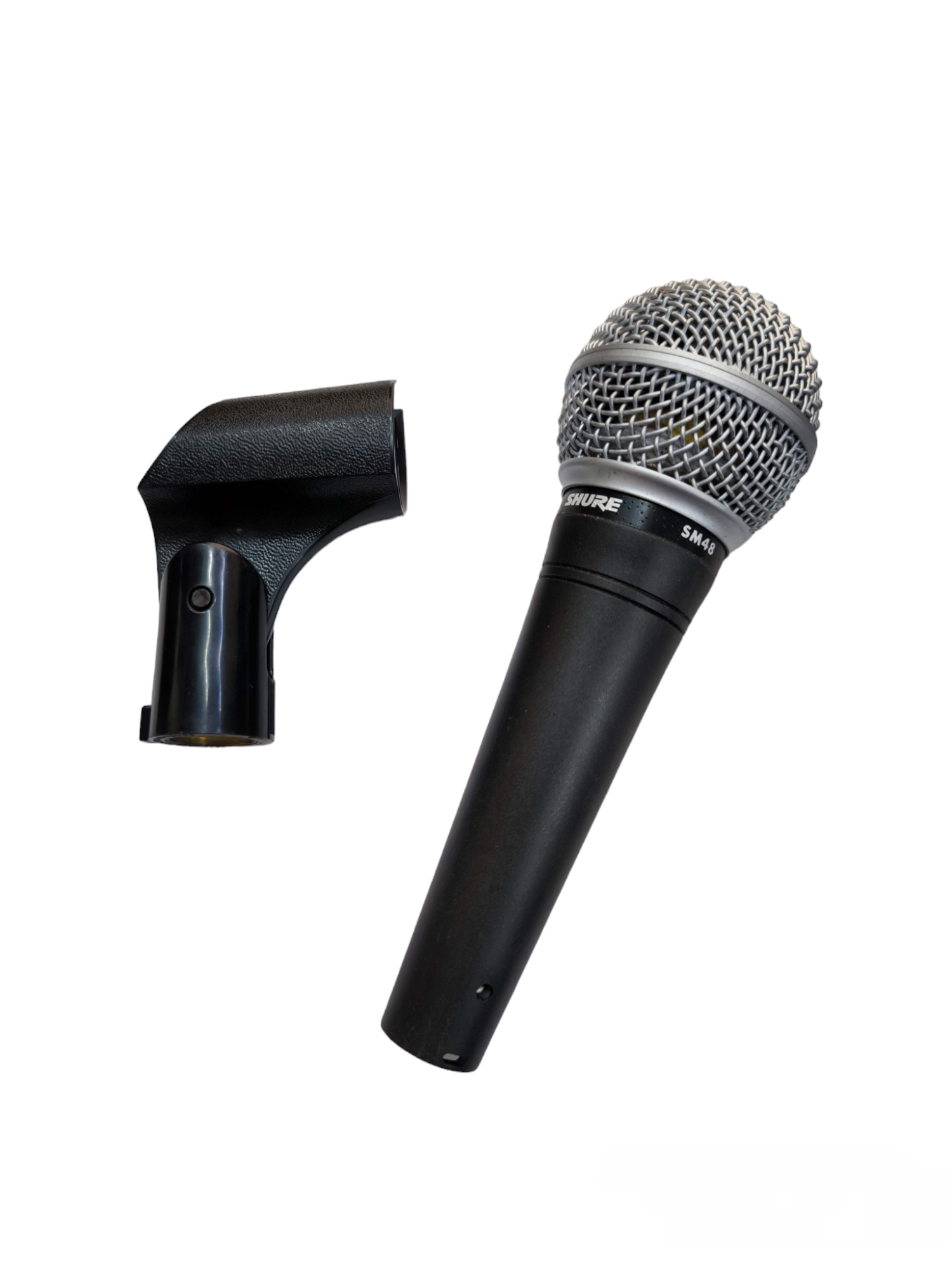 Shure Microphone Condenser with metal grille and black handle alongside black microphone clip