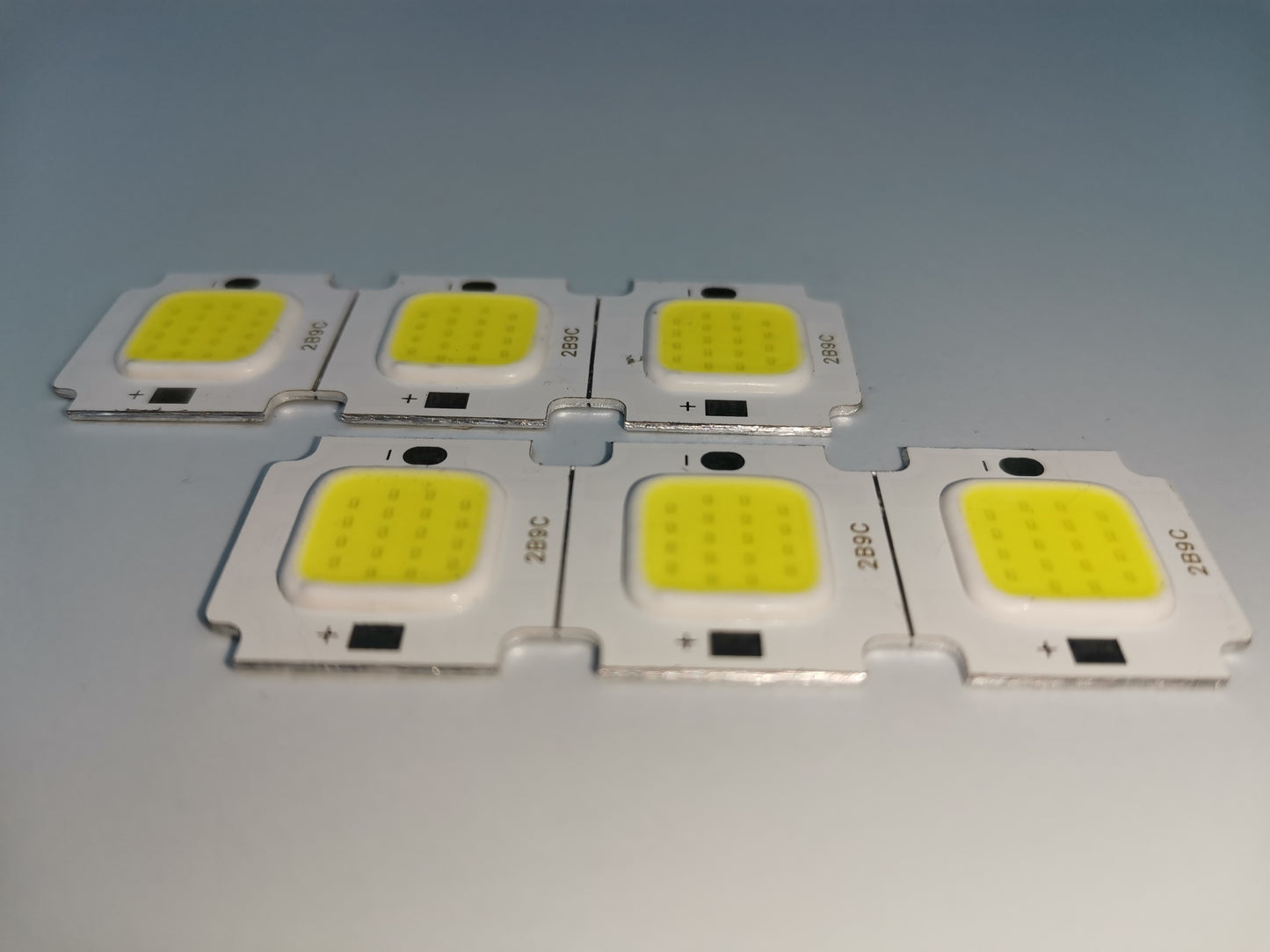 Set of six square slim LED chip 10 watt modules with yellow light-emitting surfaces on white bases