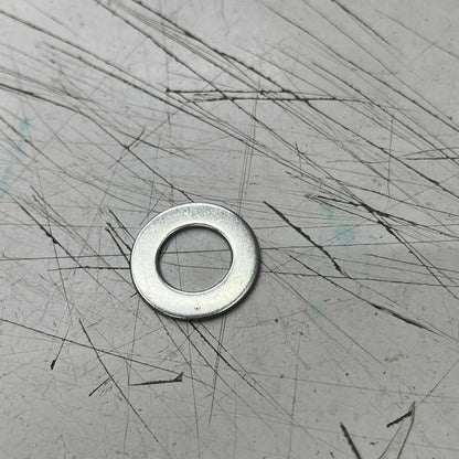 2cm Stainless Washer on a scratched metal surface for various fastening applications