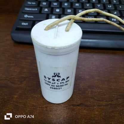 Syscap 12UF Motor Running Capacitor white cylindrical electrical part with wires on wooden surface