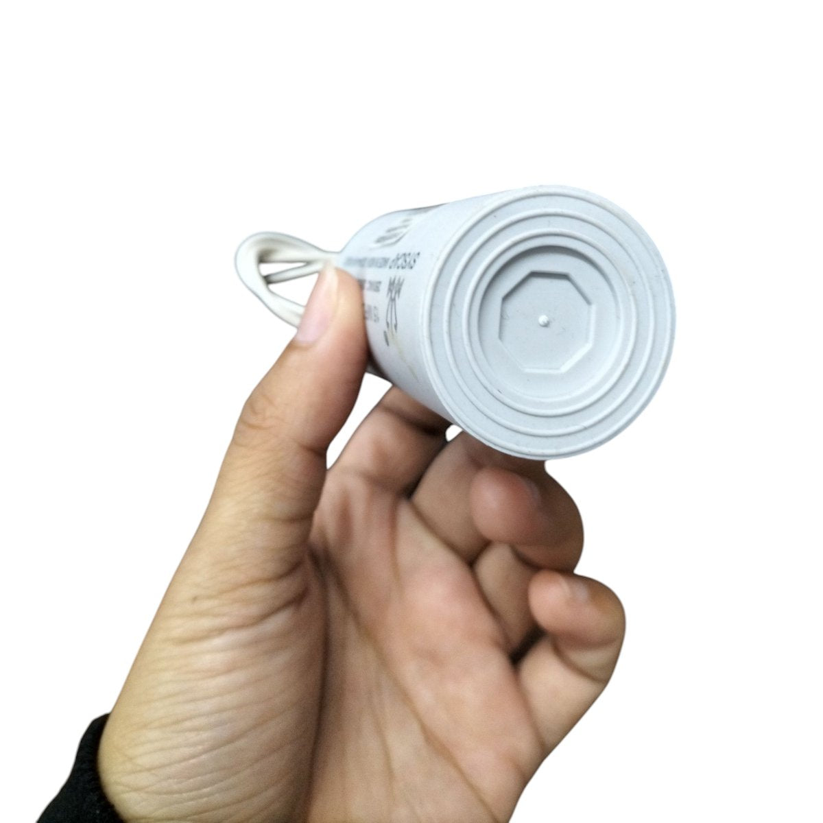 Syscap 15MFD 250V AC Running Capacitor held in hand for easy installation and connectivity.