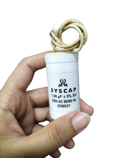 SYSCAP 350VAC running capacitor with 1.50 μF rating held in hand for electrical applications