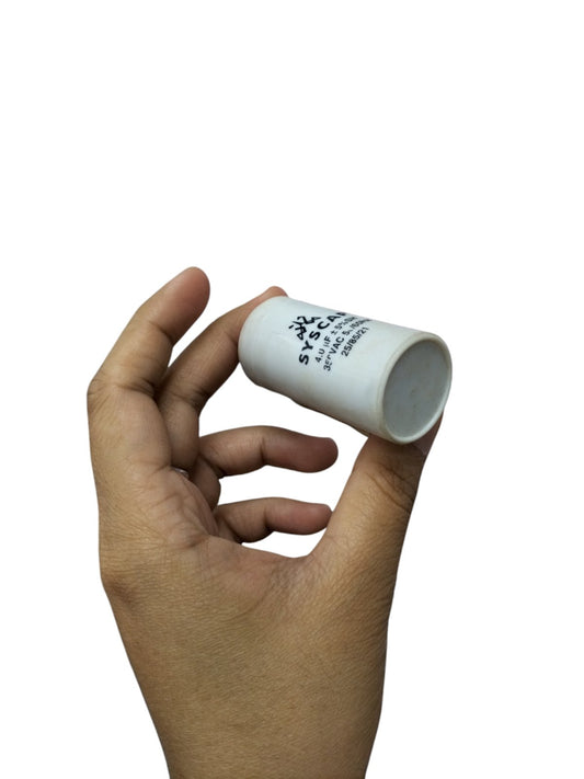 Hand holding Syscap 4MFD Motor Running Capacitor electrical part for motor circuits